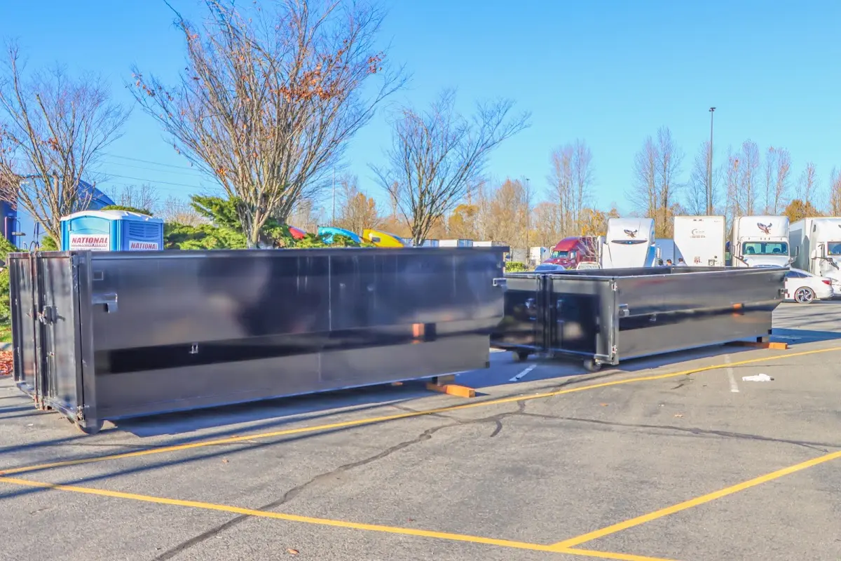 Professional dumpster rental service with roll-off container on residential driveway in Milford Mill